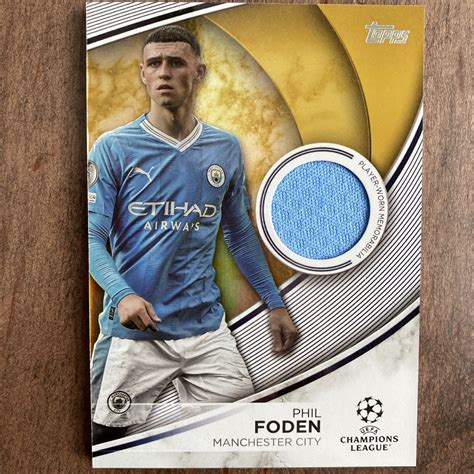 2023 24 Topps Uefa CC Phil Foden Superstar Relic Gold Relic 50