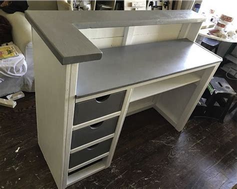 A White Desk With Drawers On Top Of It