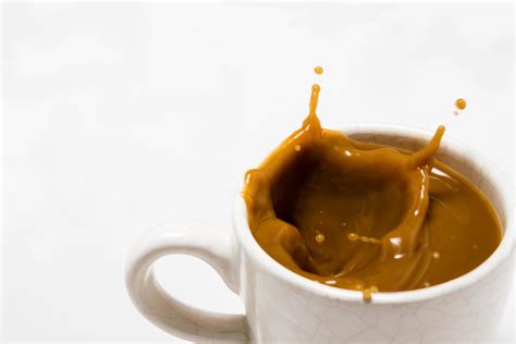 Cup Of Splashing Coffee On White Background 10718539 Stock Photo At