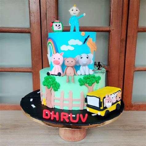 A Three Tiered Cake Decorated With Cartoon Characters