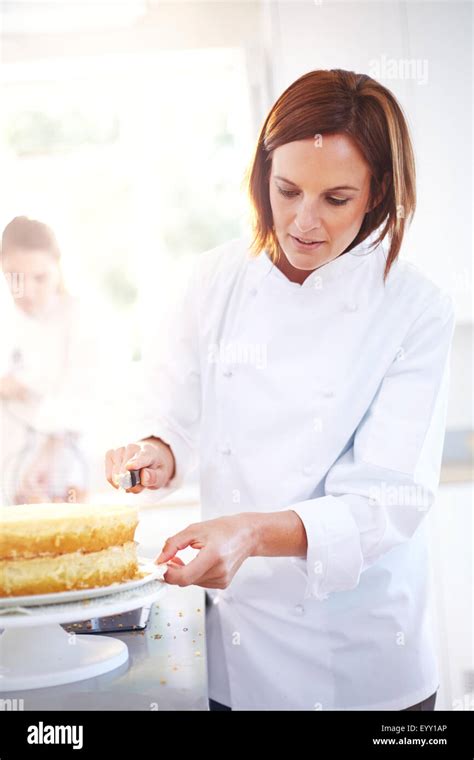 Chef Frosting Cake In Kitchen Stock Photo Alamy