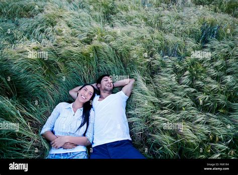 Couple laying in grass Stock Photo - Alamy