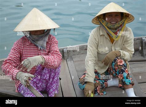 Local Women Wait For Passing Tourists To Take A Boat Trip Hoi An