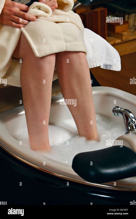 Woman Soaking Her Feet In A Foot Spa During A Pedicure Treatment Stock