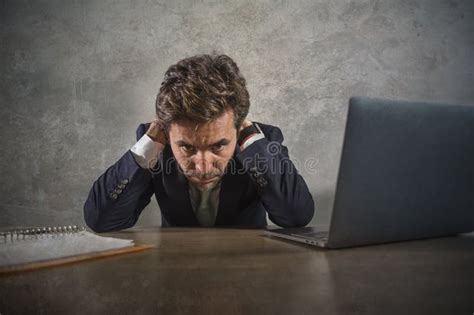 Depressed And Stressed Attractive Hispanic Businessman In Suit And Tie