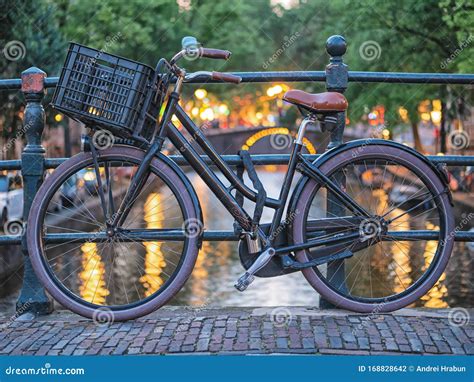 Traditional Dutch Bicycles Parked On Canal In Amsterdam Stock Photo