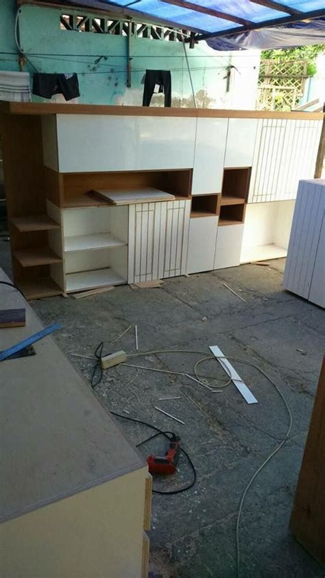 An Unfinished Room With Shelves And Tools On The Floor