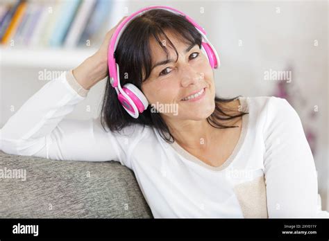 Portrait Of Beautiful Mature Woman Smiling With Headphones Stock Photo