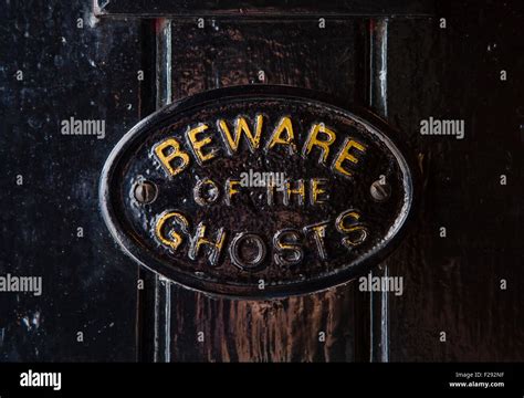 A Beware of the Ghosts plaque on the entrance to the Golden Fleece public house in York, England ...