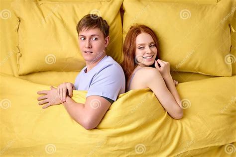 Excited Man And Woman Want Sex Lying On Bed At Home Smiling Flirting