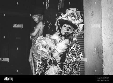 B W Portrait Of A Carnival Masked Woman In Venice Under An Arch Stock