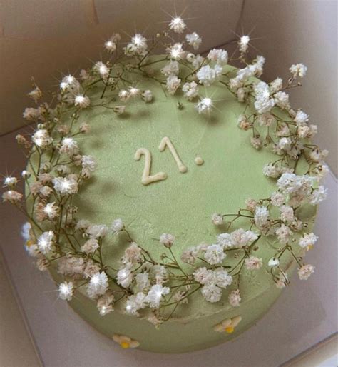 A Green Cake With White Flowers And The Number Twenty On It