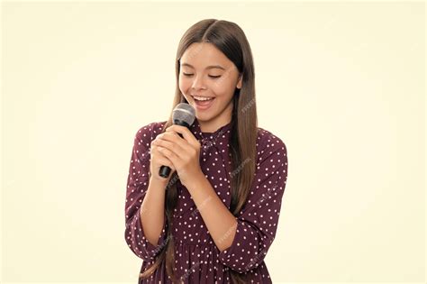 Premium Photo Cute Girl Holding A Microphone And Singing A Song