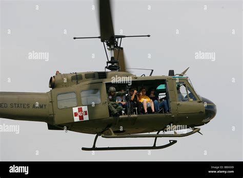 A Vietnam era UH-1 Huey helicopter flies during a Vietnam Veterans ...