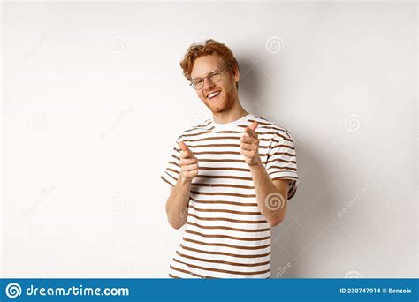 Cool And Sassy Redhead Man With Beard And Glasses Pointing Finger