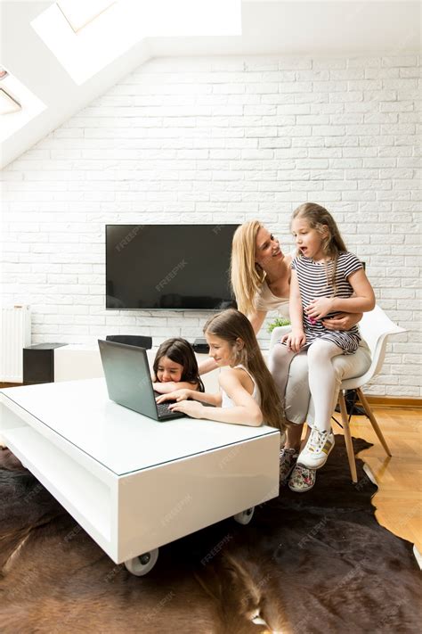 Premium Photo Happy Blonde Mother With Her Daughters Using Laptop At