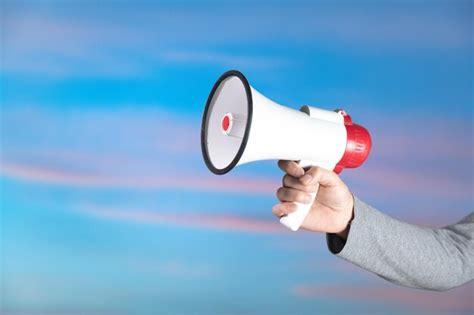 Premium Photo Hand Holding A Loudspeaker