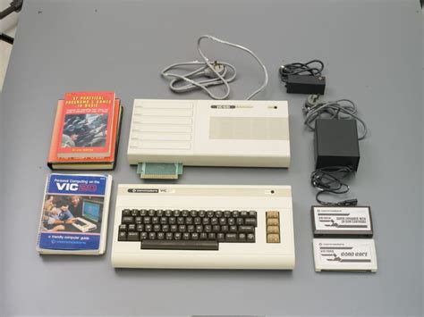 An Old Computer And Other Electronic Devices On A Table With Wires