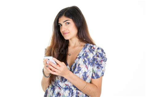 Brunette Woman Standing Indoors With Smartphone Chatting Texting With Friends Boyfriend With