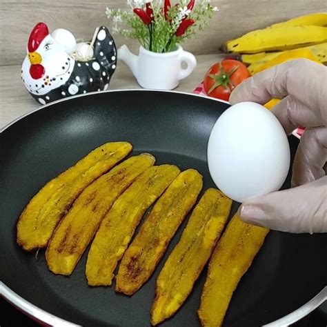 Someone Is Frying Some Food In A Pan With An Egg On The Plate Next To Them