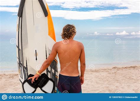 Handsome Man Walk With White Blank Surfing Board Wait For Wave To Surf