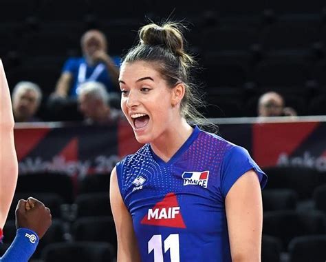 Two Female Volleyball Players In Blue Uniforms Standing Next To Each