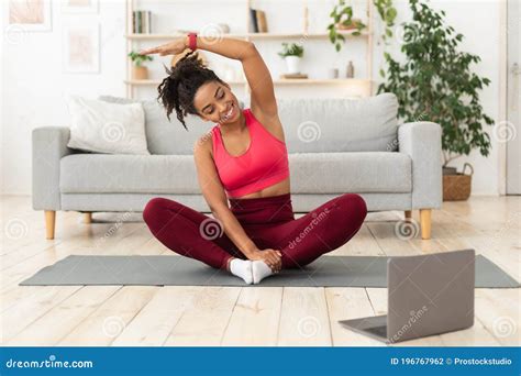 Black Woman Exercising At Laptop Having Online Training At Home Stock