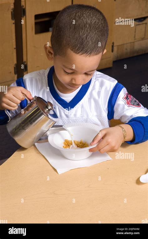 Education Preschool Classroom Ages 4 5 Meal Time Breakfast Boy Pouring