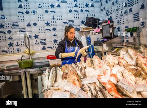 A Fish Vendor At Work In The Mercado Da Ribeira In Lisbon Portugal