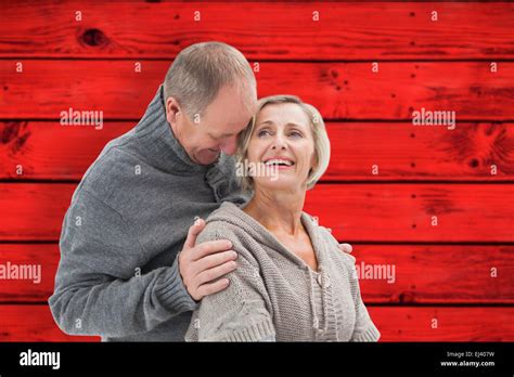 Composite Image Of Happy Mature Couple In Winter Clothes Stock Photo Alamy