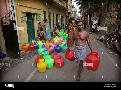 In This Monday July 15 2019 Photo Residents Wait For Water Trucks