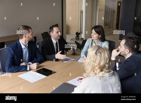 Confident Mature Business Leader Man Speaking To Colleagues Stock Photo