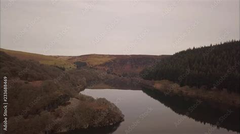 Slow drone flight 54secs over still water toward dam on reservoir at Elan Valley, Wales,UK Stock ...