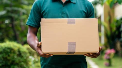 Premium Photo Person Delivering A Cardboard Box Outdoors