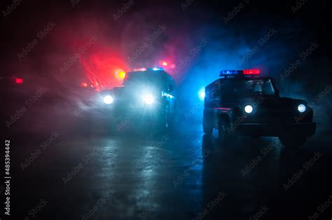 Police cars at night. Police car chasing a car at night with fog ...