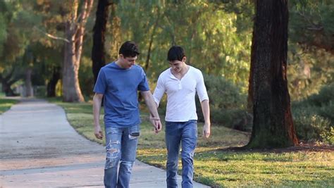 Two Young Gay Men Walk Down A Path Shot In Royalty Free Video