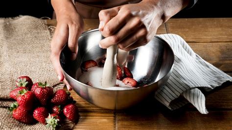 Free Photo High Angle Of Chef Mixing Strawberries And Sugar In Bowl