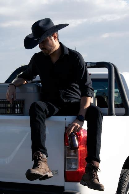 Premium Photo Cowboy Sitting On His Truck At Sunset