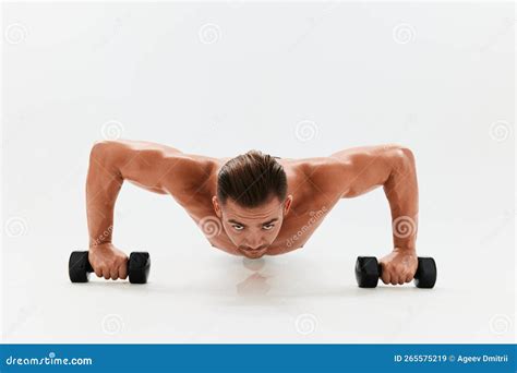 Man Athletic Body Bodybuilder Posing With Dumbbells With Naked Torso Abs Full Length In The