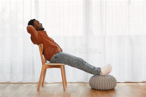 Relaxed African American Man Sitting In Chair At Home Stock Image Image Of Modern Indoors