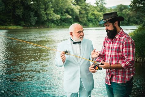 Premium Photo Two Men Friends Fisherman Fishing On River Old Father