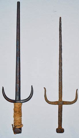 Two Old Swords Are Hanging On The Wall