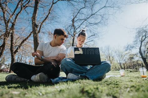 High School Students Collaborating On A Project Outdoors On Campus