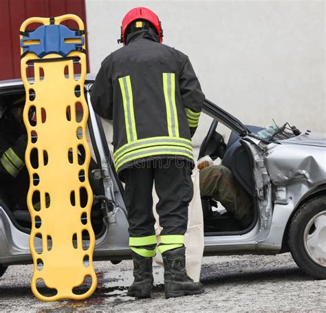 Firefighters During Rescue Of The Injured After The Car Accident With