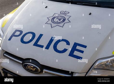 Norfolk Police Badge With The Words Police Written On A Police Car In