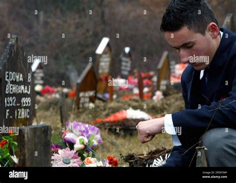 Ethnic Albanian Behar Behrami Looks Over The Graves Of His Two