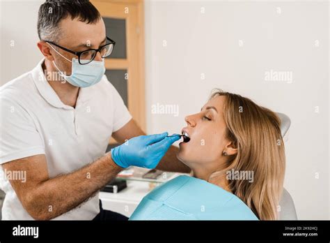 Doctor Inserts Impression Tray And Making Cast Of Teeth To Patient In