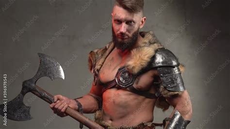 Holding Two Handed Axe Scandinavian Barbarian With Muscular Build And