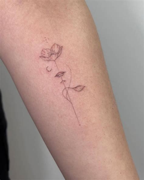 Single Needle Flower Head Woman Tattoo Placed On The