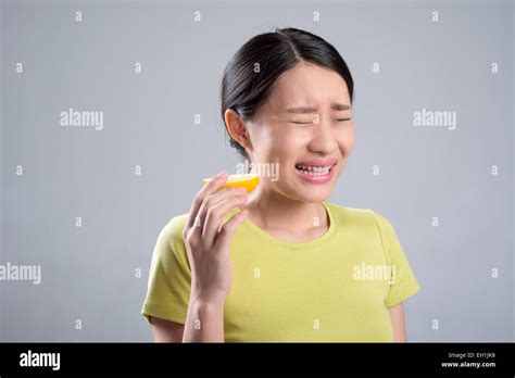 Young Woman Eating Lemon Stock Photo Alamy